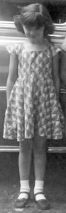 This photo shows me wearing one of the dresses that Mother made for me.