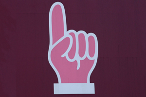 An image of a hand sign that points up.