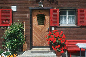 An image of windows and a red door.