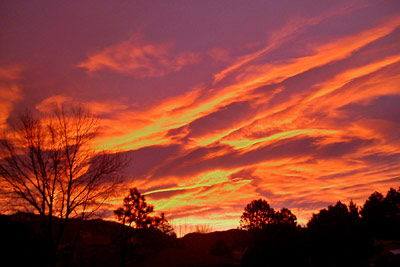 New Mexico sunrise with pink, purple, and gold Clouds.