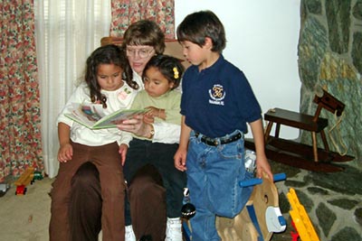 Mary Hunt Webb reads to the Jaime [pronounced, Hy’-may] children.