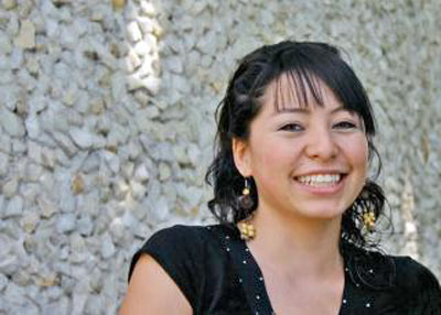 A photo of a smiling woman with black hair.