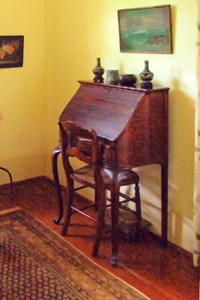 An image of an antique desk and chair in Hawaii. A desk and chair such as these would have provided a good place in earlier times for a student to do homework.