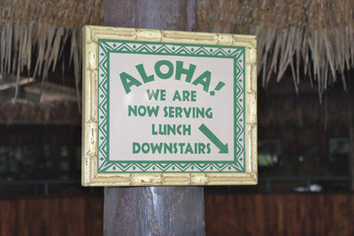 A photo of a sign seen in a Hawaiian restaurant.