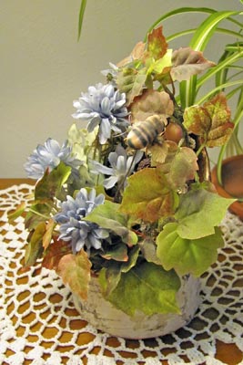 A photo of a music box that resembles a bouquet of artificial flowers.