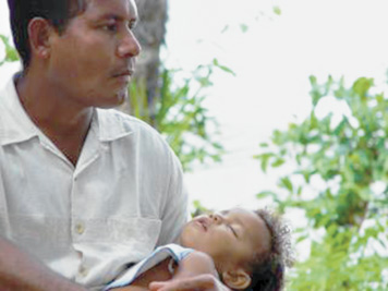 A photographic image of a baby sleeping in daddy's arms.