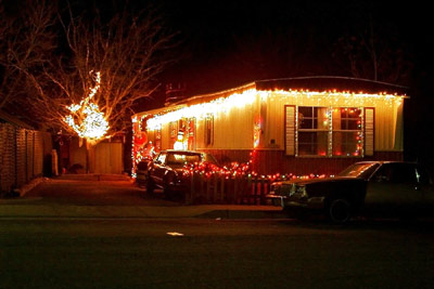 A photographic image of a mobile home adorned in Christmas lights.