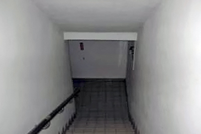 A photographic image of a bleak flight of stairs.