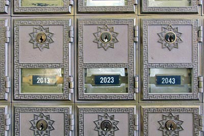 A photographic image of post office mailboxes.