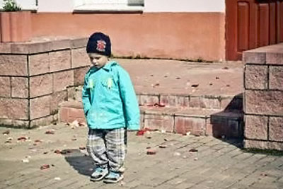 A photographic image of small boy wearing a stocking cap.