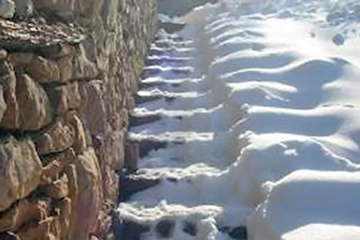 A photographic image of snowy steps.