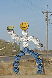 A photographic image of a man made out of tire rims.