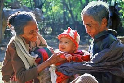 A photographic image of a mature couple with their grandchild.