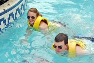 A photographic image of a swimming couple.
