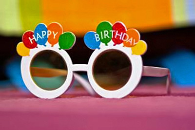 A photographic image of birthday glasses.