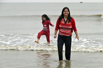A photographic image of a mother and her daughter on a beach.