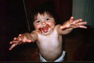 A photographic image of a toddler with chocolate on his face.