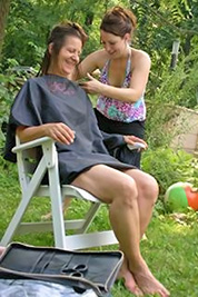 A photographic image of a lady getting her hair cut.