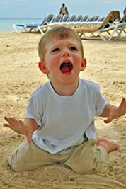 A photographic image of a boy on the beach.