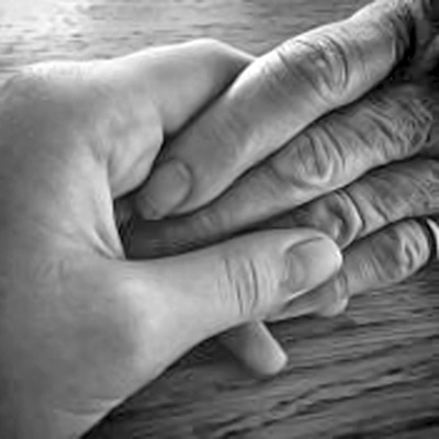 A photographic image of two hands touching.