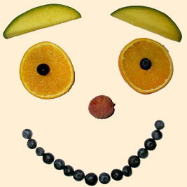 A photographic image of a face made out of fruit.