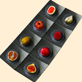 A photographic image of vitamin pills that resemble fruit.