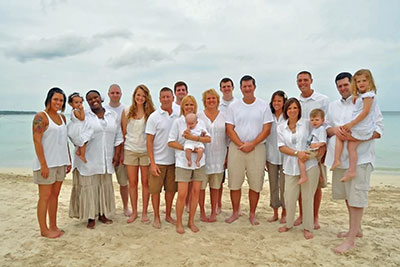 A photographic image of an extended family at the beach.