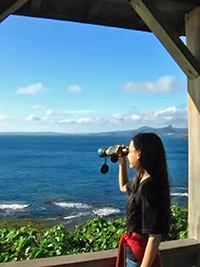 A photographic image of a girl with binoculars.