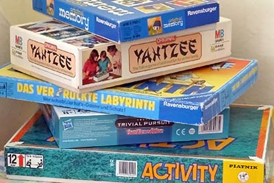 A photographic image of board games that are played while people are snowbound.