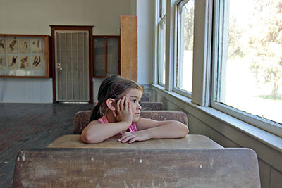 A photographic image of a daydreaming schoolgirl.