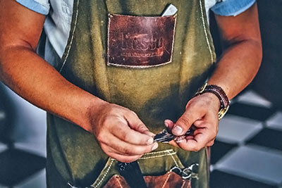 A photographic image of a man wearing an apron.