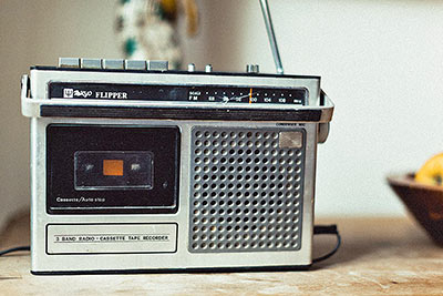 A photographic image of a vintage radio with a cassette player.