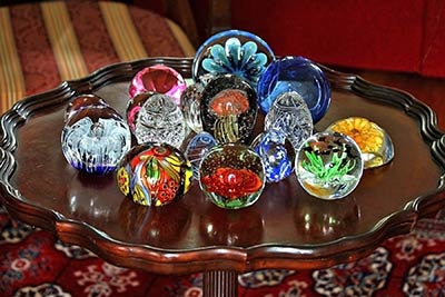 A photographic image of paperweights in a display case.