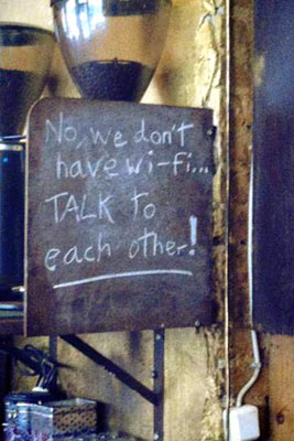 A photographic image of a humorous sign in a coffeehouse.