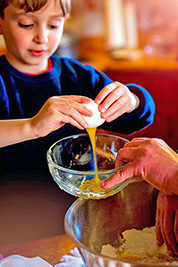 A photographic image of a child baking.