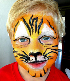 A photographic image of a child with a tiger's face.