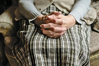 A photographic image of an old woman's hands.