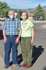 A photographic image of Morris and Mary Webb wearing masks.
