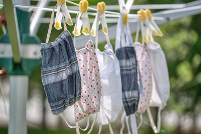 A photographic image of masks on a clothesline.