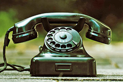 A photographic image of a dial telephone.