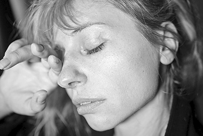 A photographic image of a worried woman.