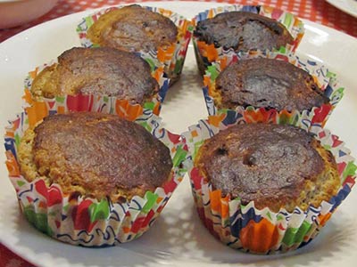 A photographic image of fresh baked muffins in party liners.