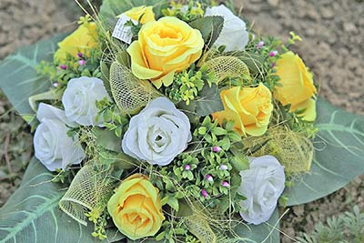 A photographic image of yellow artificial roses.