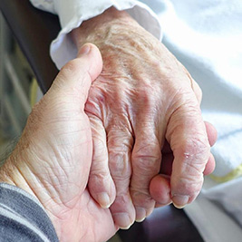 A photographic image of elderly hands.