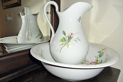 A photographic image of a bathroom pitcher and a wash bowl .