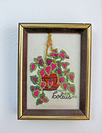 A photographic image of a crewel embroidery of houseplants.
