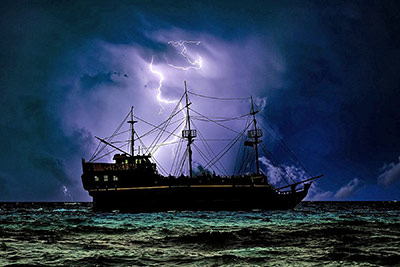 A photographic image of a ship in a storm.