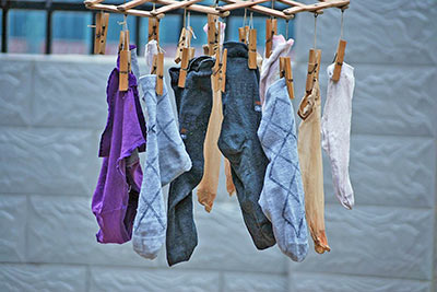 A photographic image of hosiery and men's socks drying.