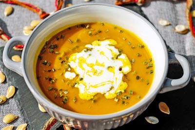 A photographic image of a bowl of pumpkin soup.