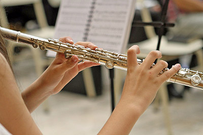 A photographic image of a student practicing the flute.